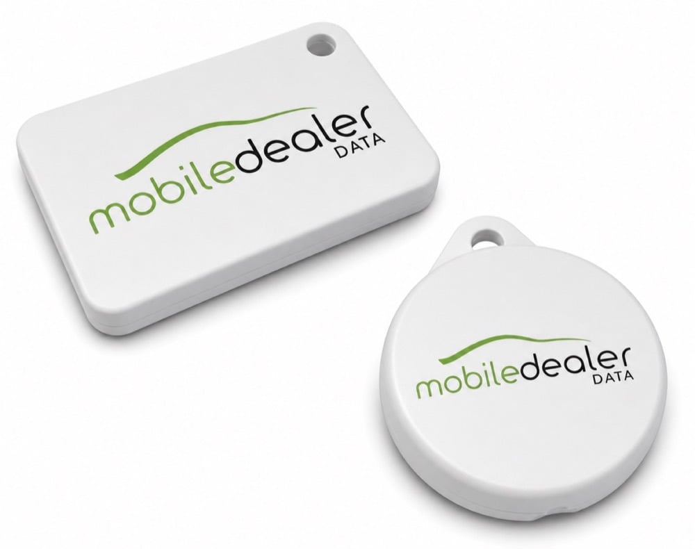 The two MDD Bluetooth tracking tags: a rectangular vehicle tag and a round key fob tag